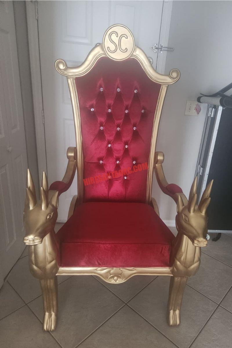 Santa photo session in Oklahoma City: a red and gold Santa chair with gifts beside it.